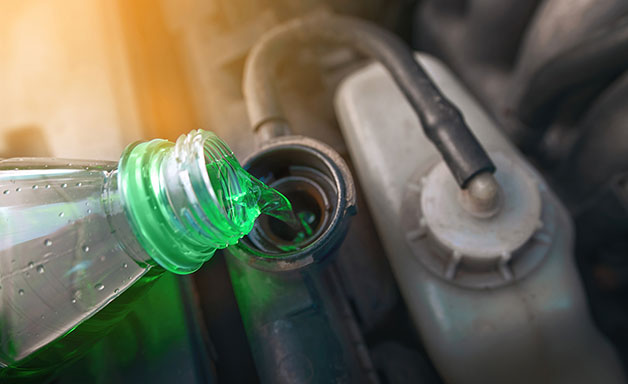 Hand filling car cooling system with coolant for cold season