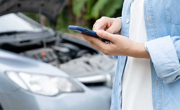 Woman uses mobile phone check insurance premiums